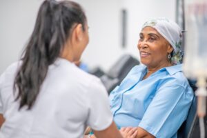 Cancer patient receiving compassionate care from healthcare professional.