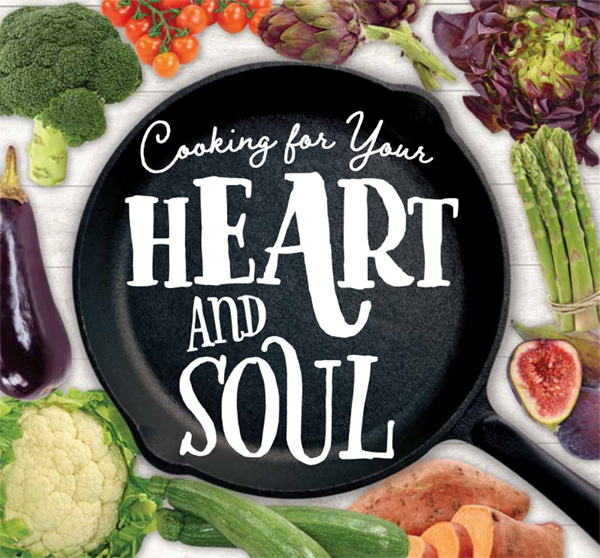 Cast iron pan surrounded by fruits and vegetables with hand-drawn lettering reading "Cooking for Your Heart and Soul"