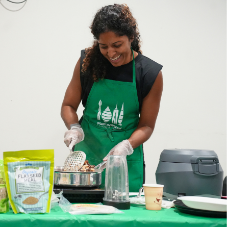 Plant Powered Metro New York's Aifra Ruiz smiling as she conducts a cooking demo.